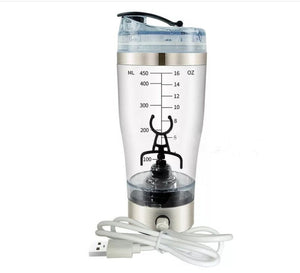A cup of portable fruit juice, electric fruit mixer, a large cup